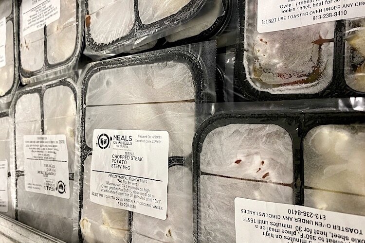 Every Friday, volunteers deliver frozen meals that can be warmed in the oven for weekend dining.