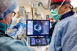 Cardiologist Dr. Hiram Bezerra talks his team through the new procedure at Tampa General.