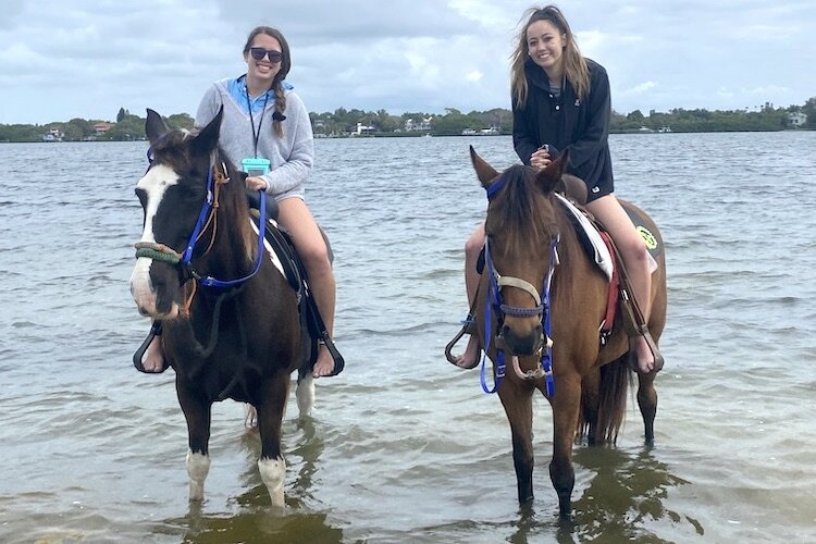 The story's author, Lauren Wong, and her friend, Haley, enjoy a day of horseback riding in the Gulf. 