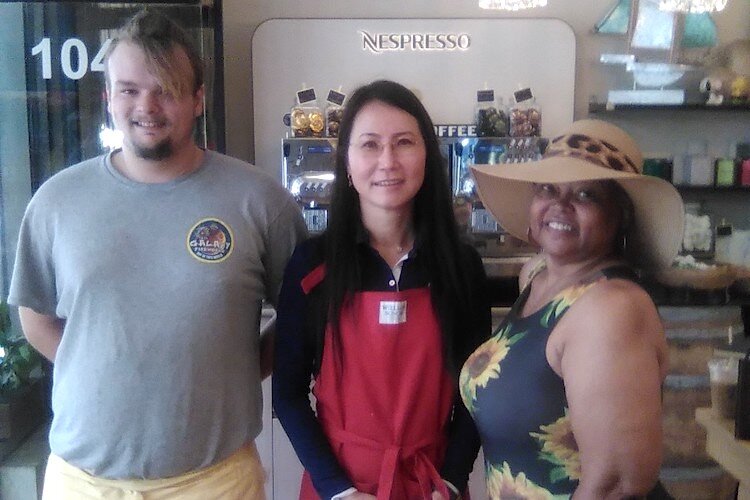 Store manager Brandon, Owner Adrian Nagy, and shopper Gloria Royster. 
