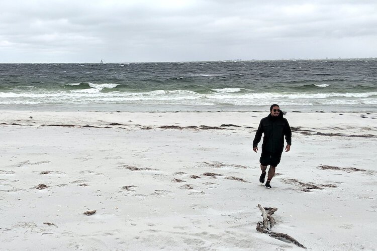 Quenton Cypress, Community Engagement Manager for the Seminole Tribe of Florida, strolls the beach at Egmont Key.