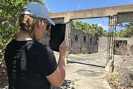 Patel College Sustainable Tourism graduate student Samantha Vorce takes 3D scan imagery of a circa 1900 warehouse on Egmont Key.