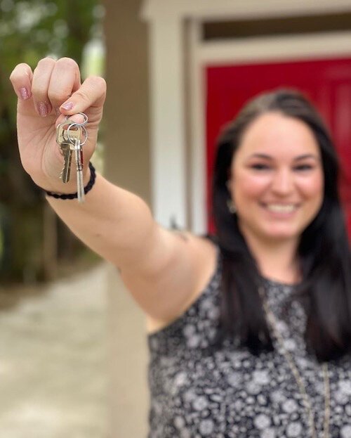 A happy new homeowner shows off her new set of keys.