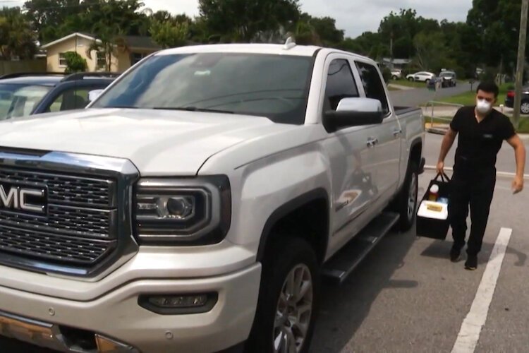 Ledseil Garcia, pharmacy technician for DeliveRxd Pharmacy, heads out on his appointed rounds in Pinellas and Hillsborough counties to deliver free COVID-19 vaccines to people at their homes.