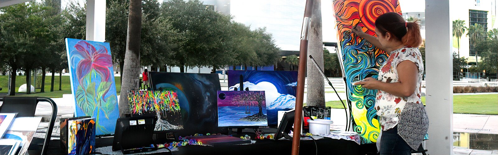 Artist Crystaline Rojas of A Splash Of Passion Art contributes to the event at Curtis Hixon Park by creating a new artwork.