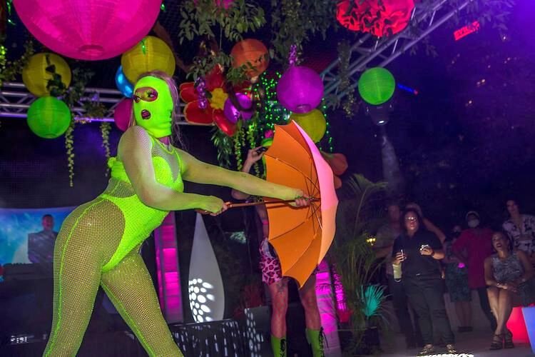 "Aquarius" and other dancers, drag queens, and performers strut their neon for the crowd at Pride & Passion.