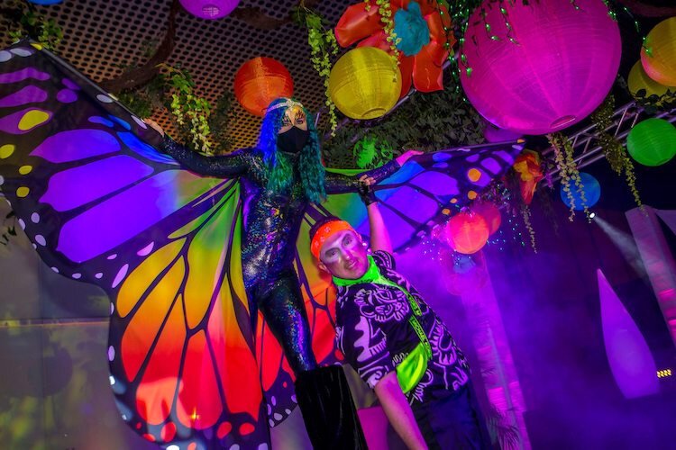 A flying butterfly makes a dramatic entrance on stilts.