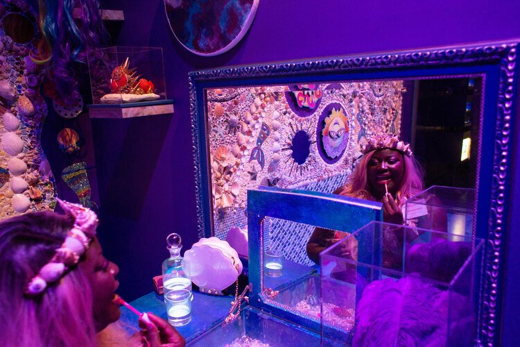 Iona Parris greets guests in the Mermaid Dressing Room she created with decorative sea shells. 