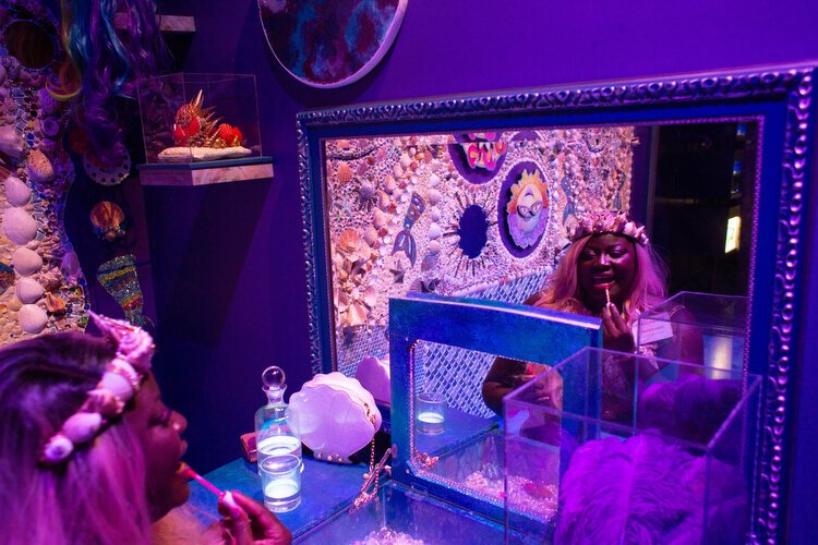 Iona Parris greets guests in the Mermaid Dressing Room she created with decorative sea shells. 