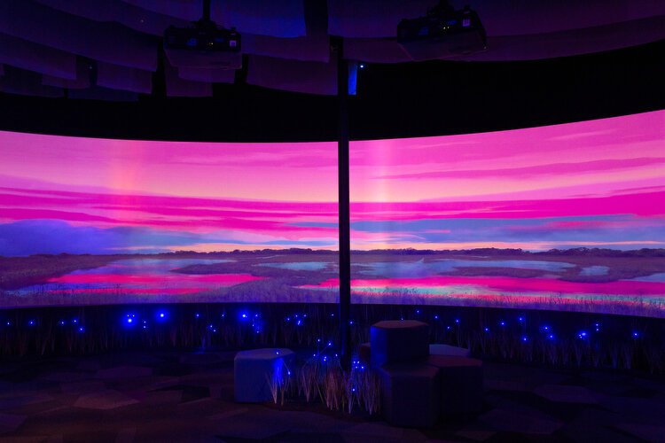A giant production screen shows the Everglades from sun up to sun down in 15-minute loops. 