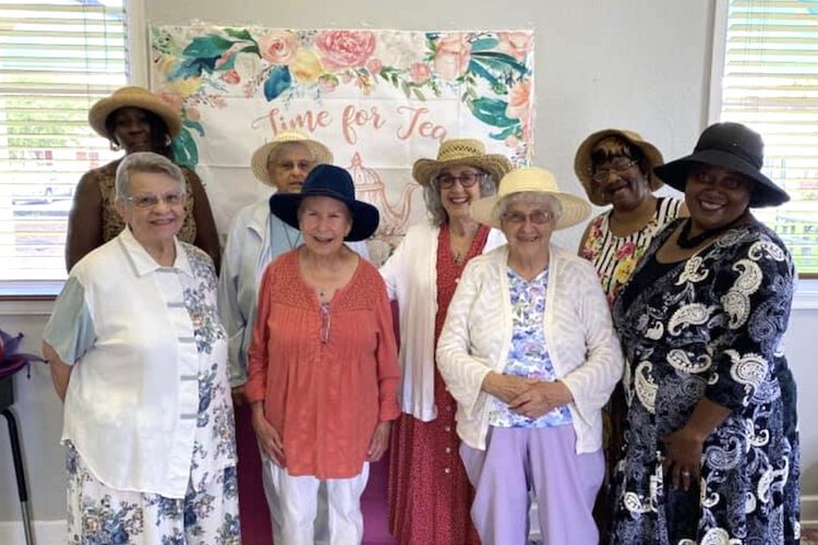 Senior residents and staff gather for tea.