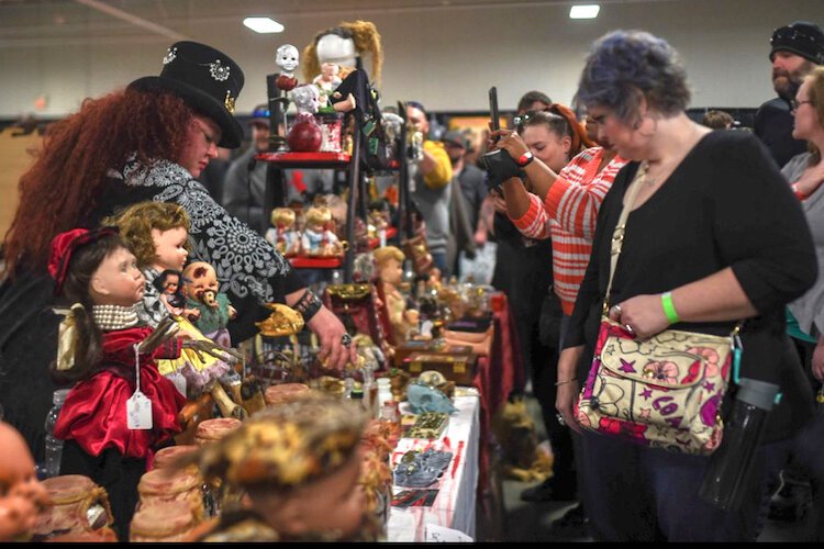 Visitors enjoying going through the unusual items for sale at the Oddities and Curiosities Expo.