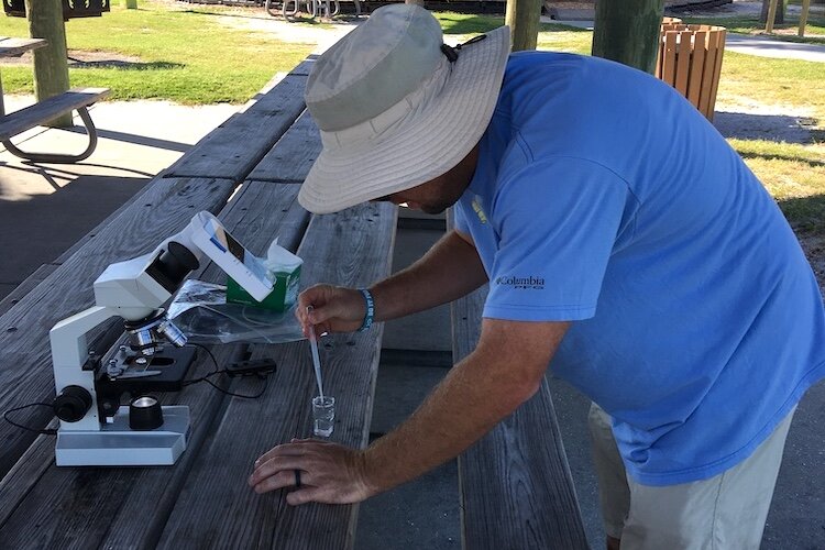 A picnic table becomes a DIY marine bio lab to analyze water samples incredibly portable HABscope tool.
