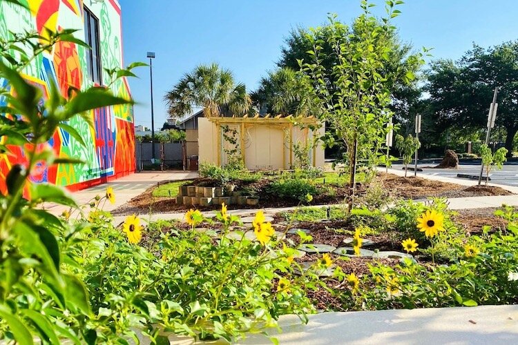 Grounds4Art@HCC's most recent public art installation, "NEST (Nourishment, Education, and Social Terraces)" by artist Tory Tepp, with mural "Infinite Transitions" by Jay Giroux and Edgar Sanchez in the background.