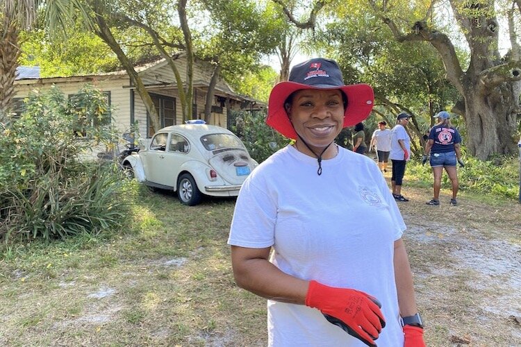 City of Tampa Fire Chief Barbara Tripp pitched in for a recent neighborhood cleanup by volunteers recruited by the Center for Economic Development..