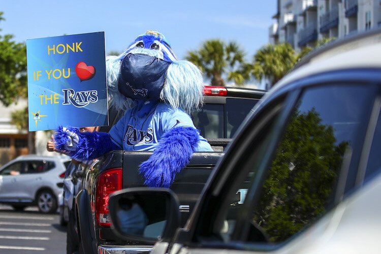 A masked-up Raymond stirs up fans on the streets around Tampa Bay.