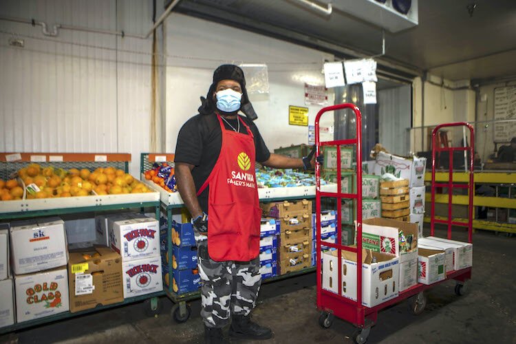 Produce clerk Jose Pedro says there is never a slow day at Sanwa but on Mondays and weekends, he estimates he passes between the customer produce section and the supply area about 50 times more than during the week.