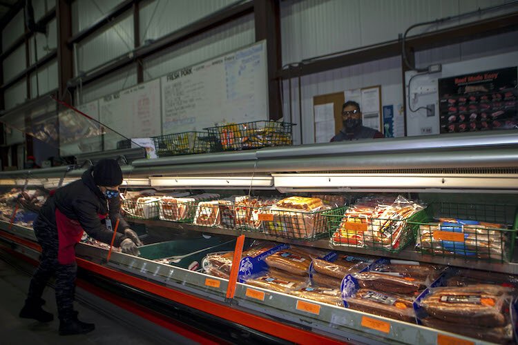 Sanwa Meat Department  Manager Angel Maldonado oversees clerk Yerica Gomez, as she continuously checks supply dates, rotates, and stocks all meat and poultry products.