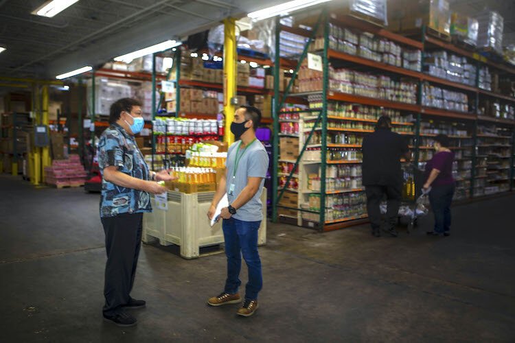 Sanwa proprietor Wesley Leung, right, discusses supply demands with buyer Vi Luu.