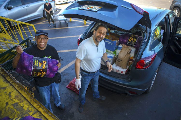 Al Mora, right, proprietor of Lima Limo'ne Peruvian Cuisine on Busch Boulevard, loads his car several times a week with fresh fruits, vegetables, and restaurant supplies.