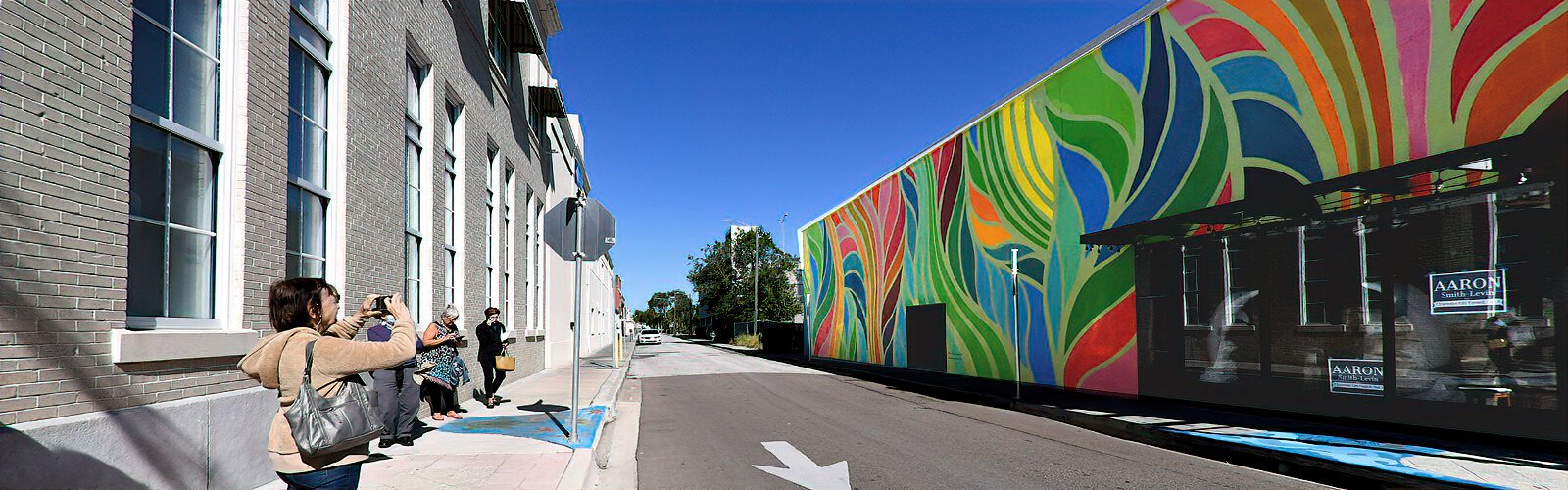 “Elysian Times” by St. Petersburg artist Cecilia Lueza transforms a Clearwater intersection into a celebration of color. At the feet of tour participants across the street lies a storm drain mural painted by Largo High School students.