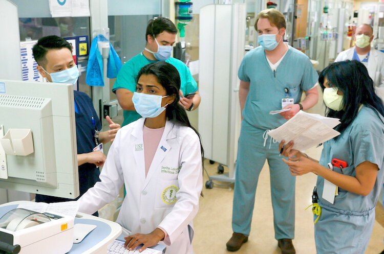 Dr. Seetha Lakshimi and medical team members with Tampa General and USF at work in the Global Emerging Disease Institute at Tampa General.