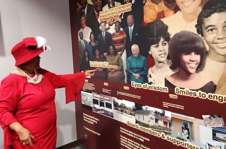 Chloe Coney admires the new legacy wall honoring her life and community service. A portion of the wall at the CDC of Tampa shows Coney from childhood to teenager. She was among the first Black students to integrate Hillsborough County public schools.