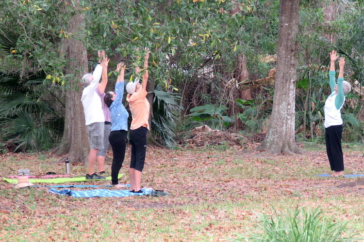 Members enjoying a good morning stretch led by VISTA Gardens President Jennifer Grebenschikoff who bicycles to the garden.