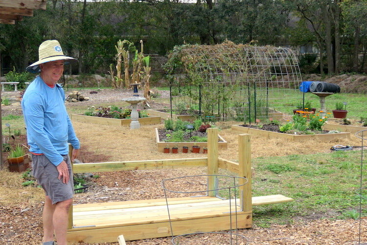 Evans Bostick, Chair of the Garden Committee, modifying a table made by Eagle Boy Scout Troop 9 for physically challenged members who will benefit from a raised garden bed.