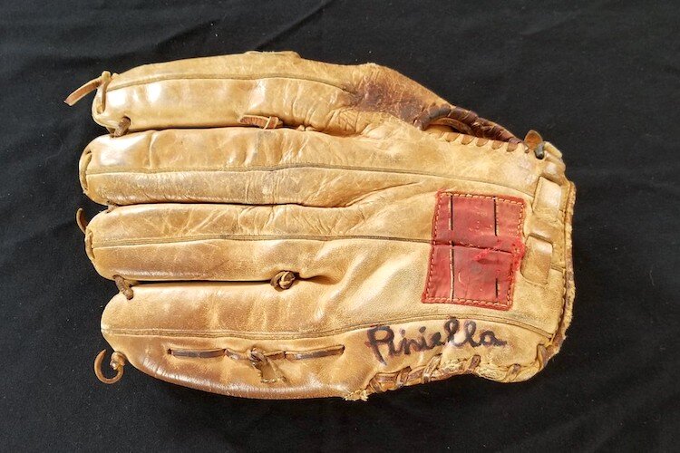 A glove worn and signed by baseball great signed Lou Piniella.