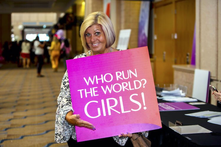 Laura Zarrate of Athena CPA poses with one of the many inspirational messages and props distributed throughout the Convention Center.