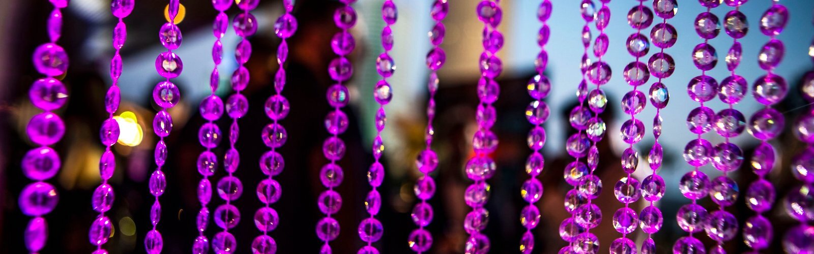 Guests mingle among curtains of beads and baubles.