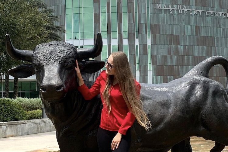 Anastasiya Pylypenko posing with the USF bull.