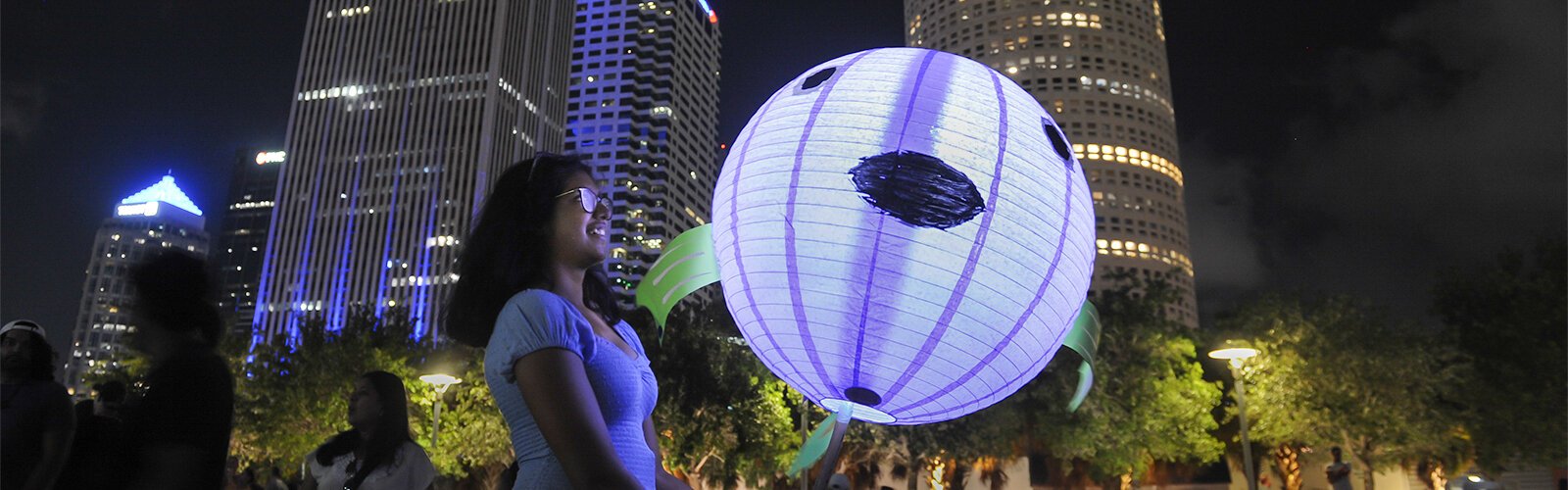 Bhavya Bansal, 15, holds her lantern after arriving with her family at Curtis Hixon Park during the Lantern Parade Saturday night.