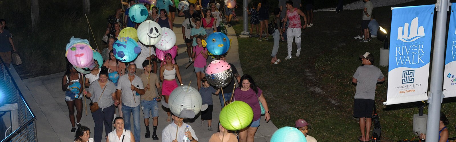 The Riverfest Lantern Parade moves along Riverwalk Saturday night.