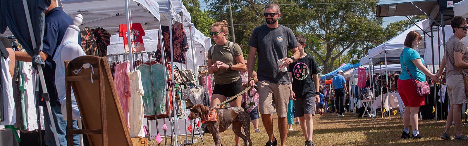 Alee Al-Raee of Largo walks his German short-haired pointer “Jasper” among the vendors at The Marker Marie on Saturday. Alee was with his 11-year old son, Arriq Al-Raee, and fiancé, Erin Gyros.