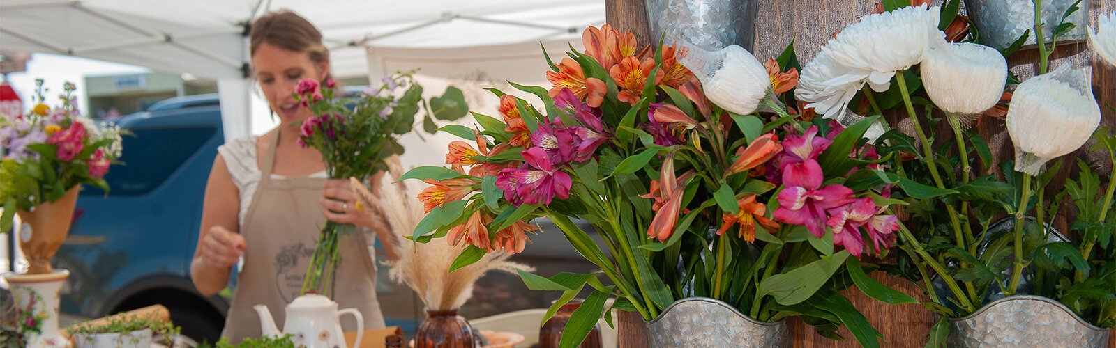 Allison Gulino works on a bouquet of flowers for a customer at The Market Marie in Clearwater Saturday. Gulino, from Clearwater, runs the Little Bird Flower Shop and was one of the many vendors at the market.