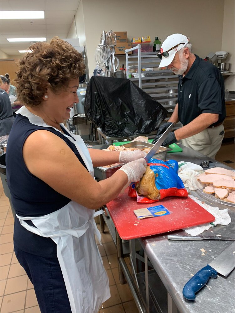 Volunteers at South Tampa Fellowship prepare Thanksgiving meals for Afghan refugees.