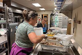 Volunteers with South Tampa Fellowship prepare meals for Afghan refugees who have settled in Tampa Bay. 