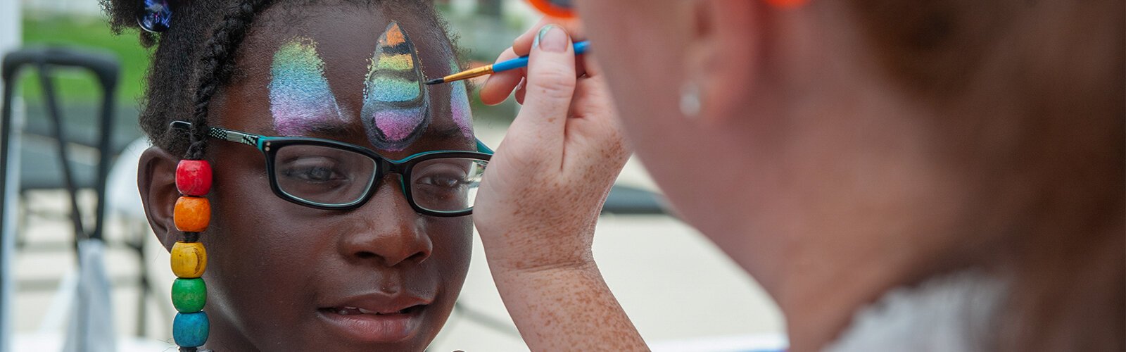 Destiny Mickell, 8, of Tampa, gets her face painted in the vendor area of this year's St Pete Pride Parade. Destiny moved to Tampa from Illinois with her family three weeks ago.