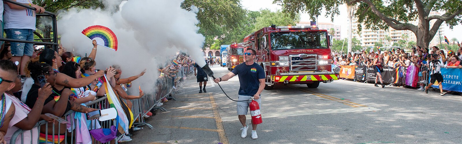  A firefighter from St. Pete Fire and Rescue's Palmetto Park fire station sprays a fire extinguisher into the crowd at this years St Pete Pride Parade.