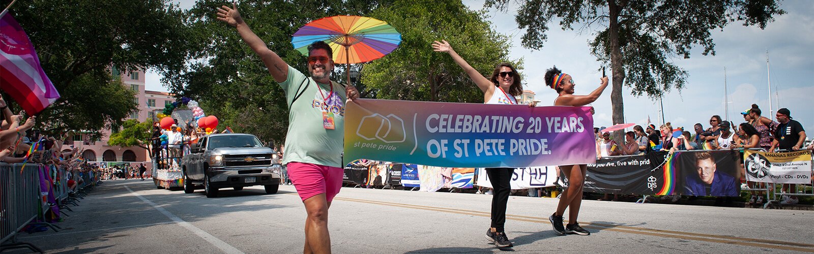 A banner near the front of the St. Pete Pride Parade announces the event's 20th anniversary.