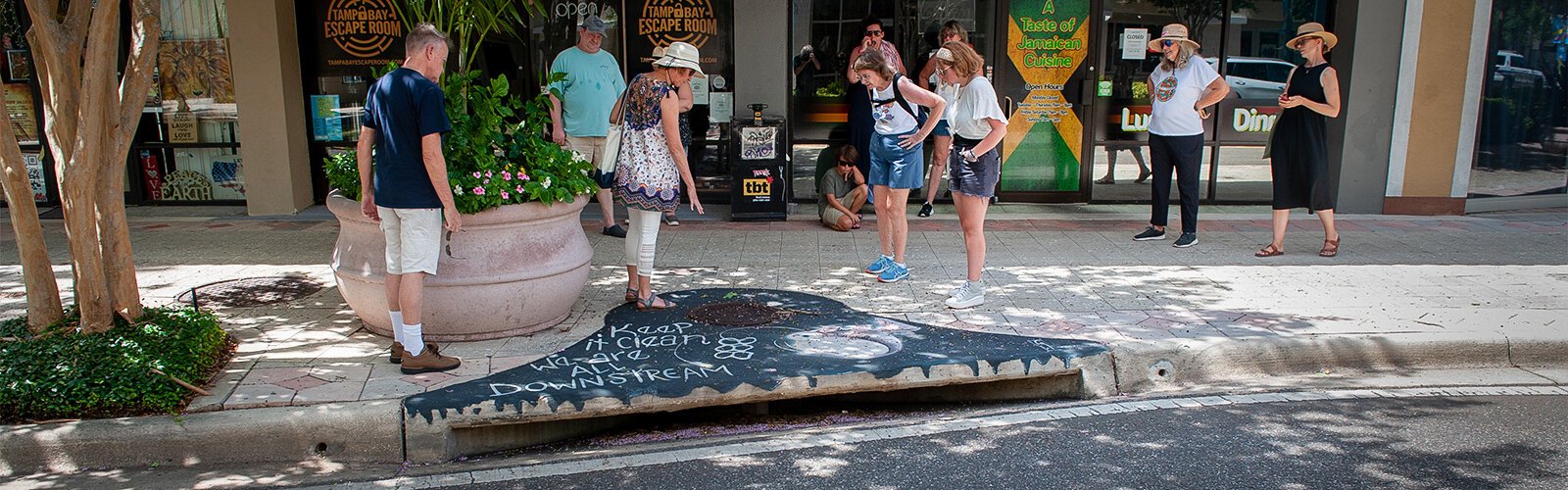 Artist Grayson Wolfe titled this sewer drain painting “Keep It Clean, We Are All Downstream." The painting depicts an anglerfish saying the phrase.