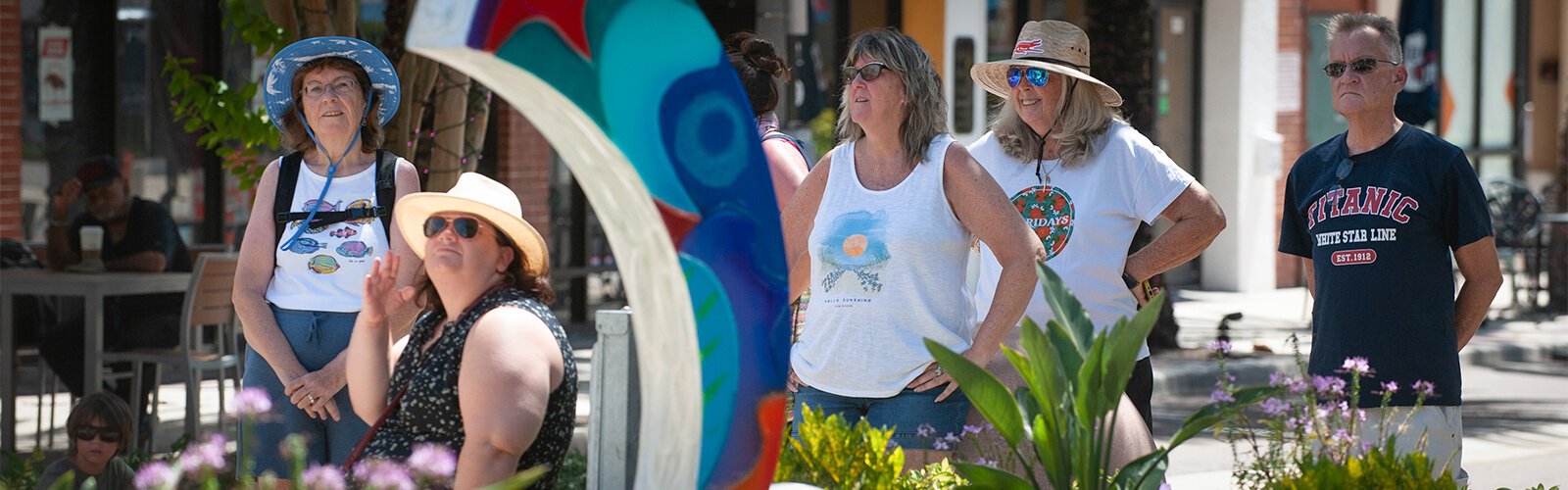 Walkers in the Clearwater Arts Alliance's public art walk look at work by artist Clayton Swartz titled “Festival Blue” as they listen to guide Roberta Klar describe the work.