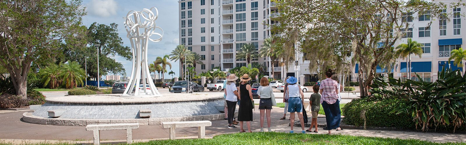 The group for Saturday’s 10:30 am walking tour gather at an art piece by artist Lucy Keshavarz titled “Ring Canopy."