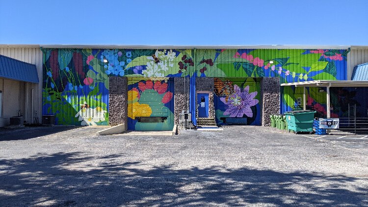 Local artist Laura Spencer's mural "Garden Variety" on the Mother Kombucha warehouse in Lealman  is part of a Creative Pinellas effort to create public art and promote local artitsts.