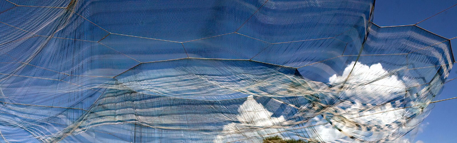  Clouds seem to have been captured in the "Bending Arc" billowing net artwork of Tampa Bay native Janet Echelman. The wind keeps the sculpture over the tilted lawn in perpetual motion.