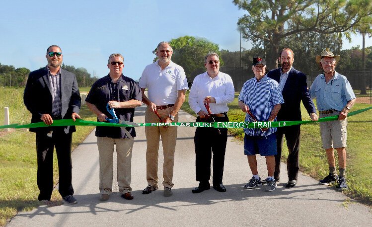 Current and former officials gather for a ribbon-cutting of the new stretch of the  Pinellas Trail Loop system.