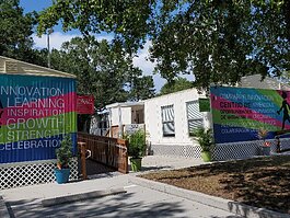 Modular buildings, with colorful murals, serve as classroom and meeting space at Enterprising Latinas.