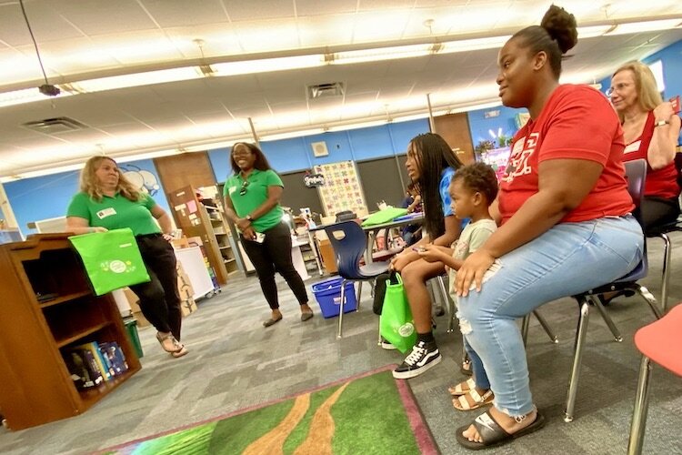 The mother of a Dunbar Elementary student who went through the Sing Out and Read Program looks on during the recent celebration event at the school.